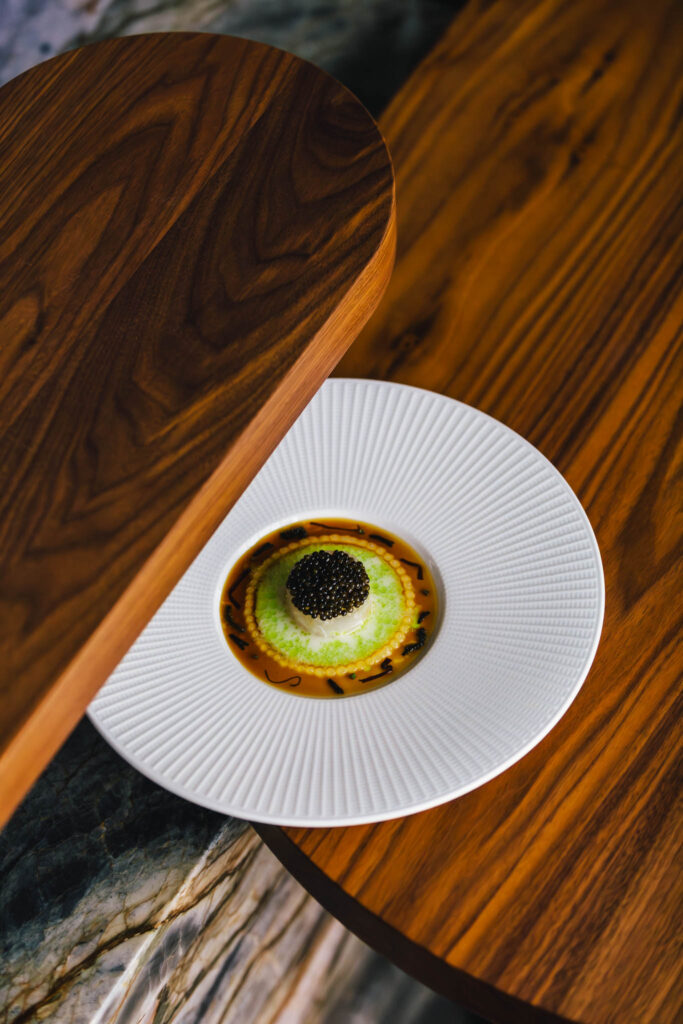 Signature seabass and caviar dish at ate chef's table restaurant até at luxury boutique hotel The Dylan Amsterdam, part of The Leading Hotels of the World and awarded by Gault & Millau.